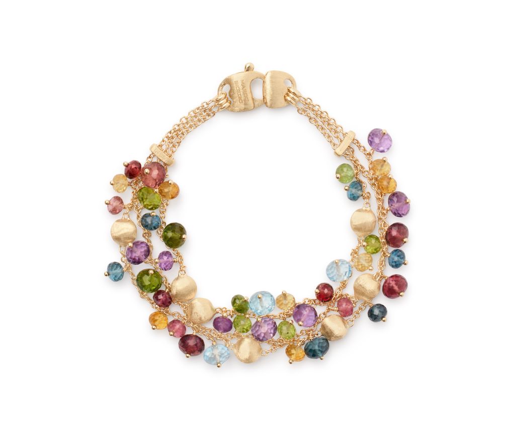 A gold bracelet featuring multiple chains adorned with colorful gemstone beads in assorted shapes and hues.