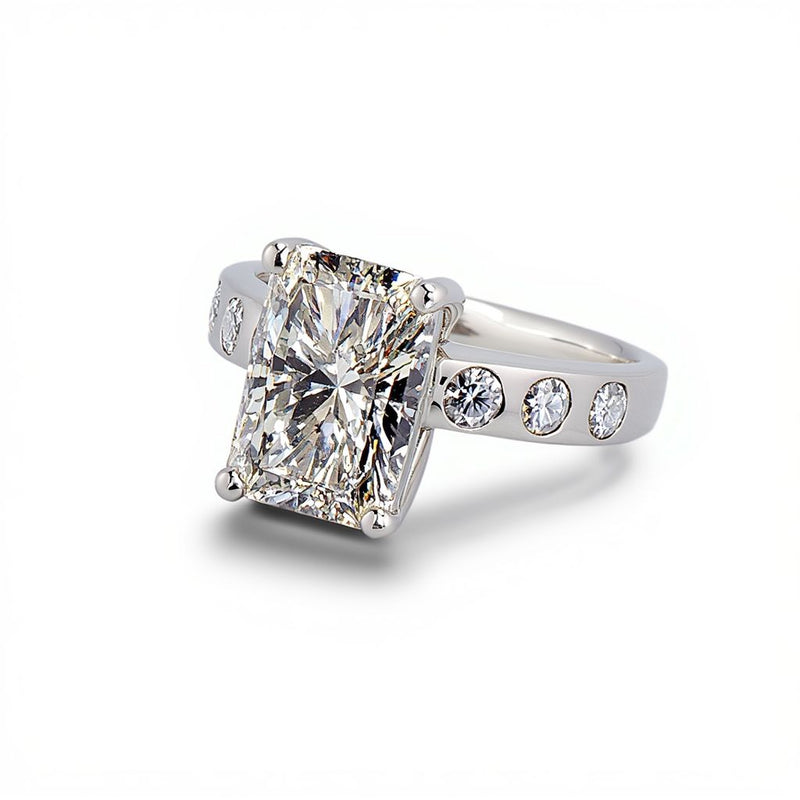 A striking platinum engagement ring showcasing a large radiant cut center diamond and round brilliant diamonds flush set into a thick band by a custom jewelry creator