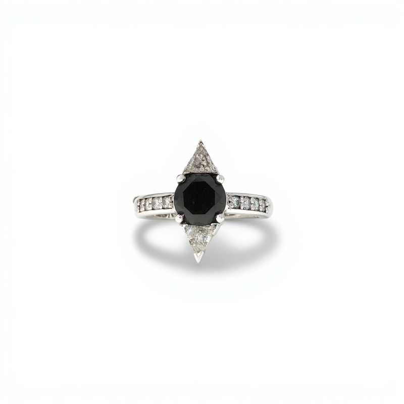 A contemporary open cuff ring in polished yellow gold featuring an oval white diamond on one tip and a round black diamond on the other by a custom jewelry creator